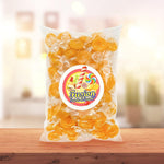 Hand holding an individually wrapped butterscotch candy