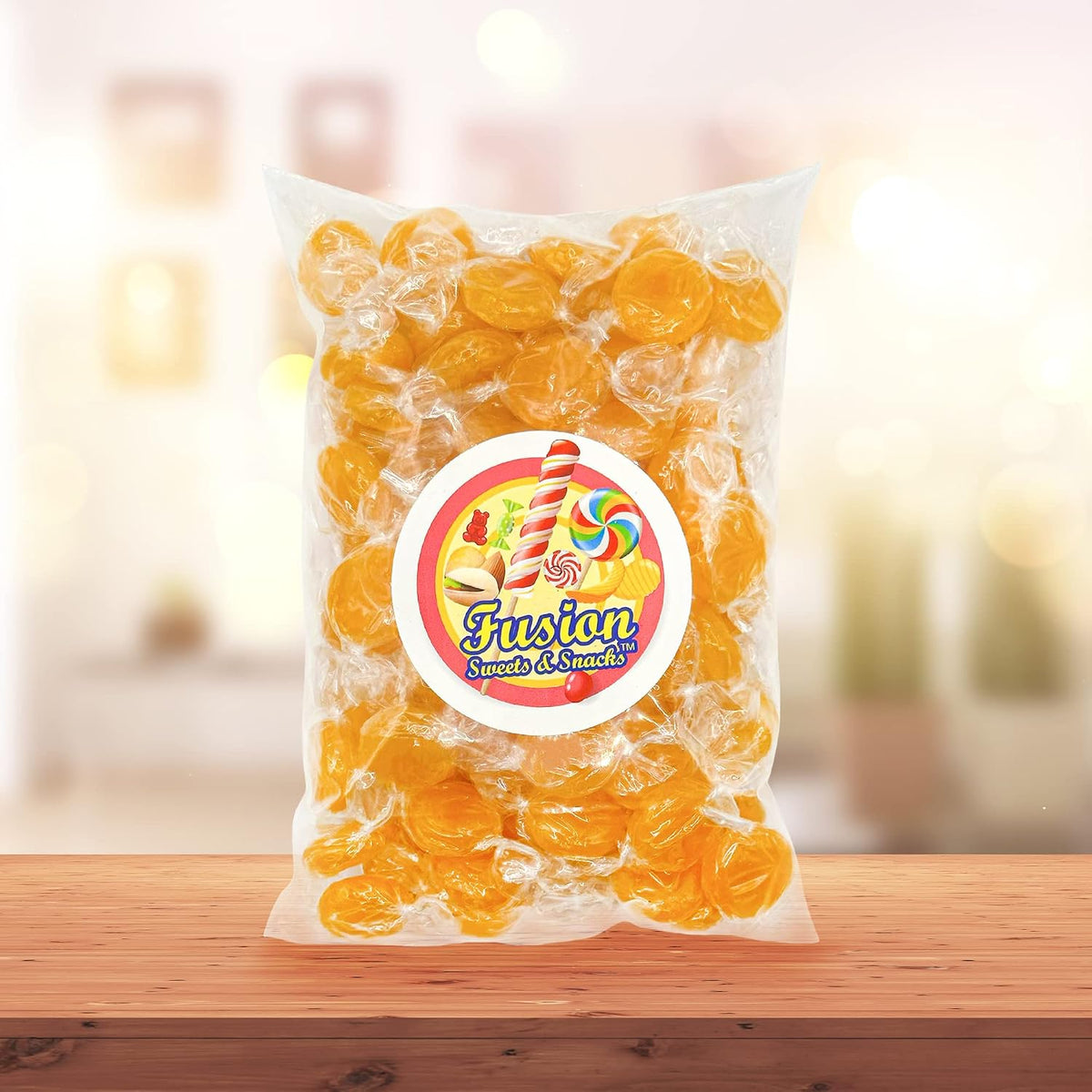 Hand holding an individually wrapped butterscotch candy