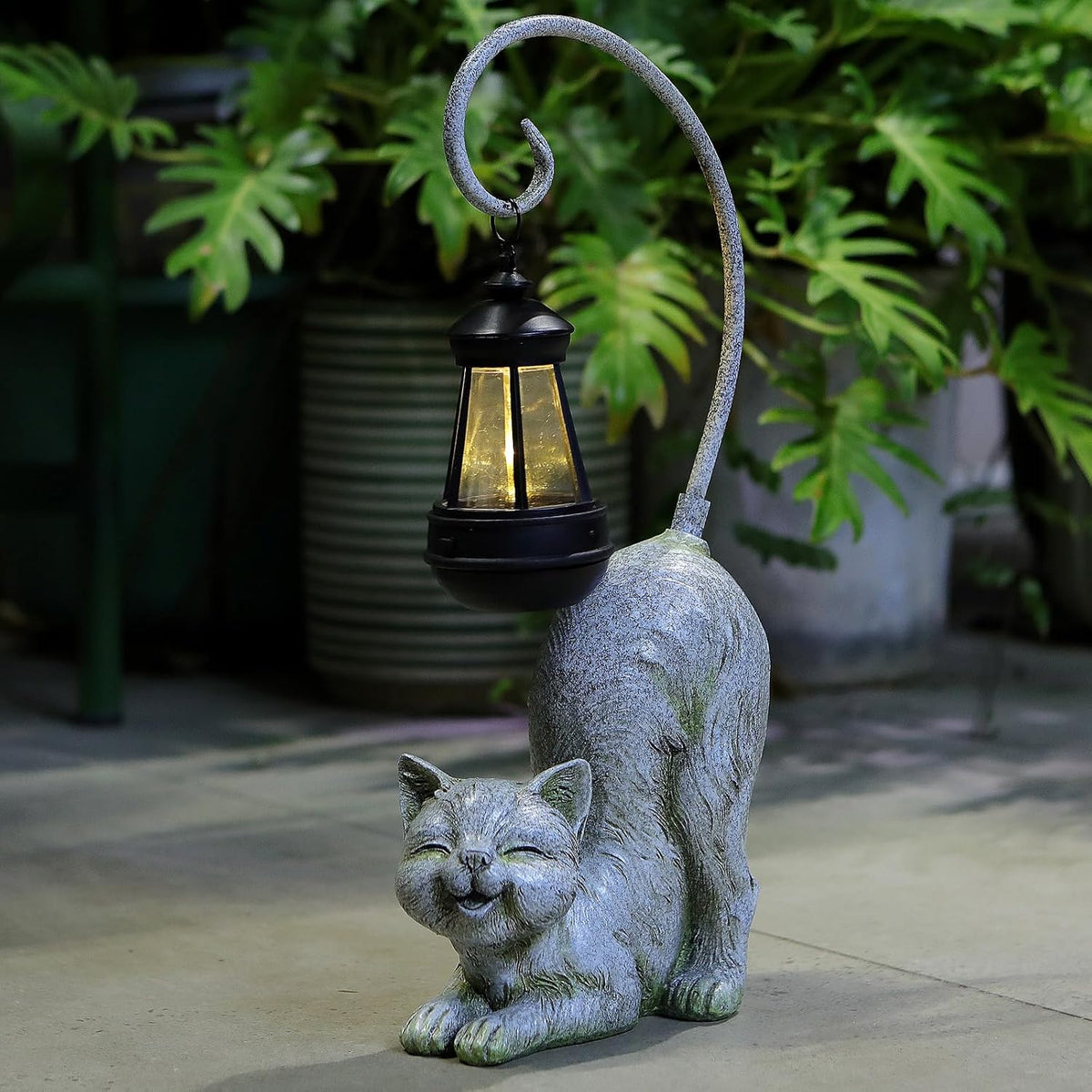 Hapyard Laughing Cat outdoor statue illuminated at night