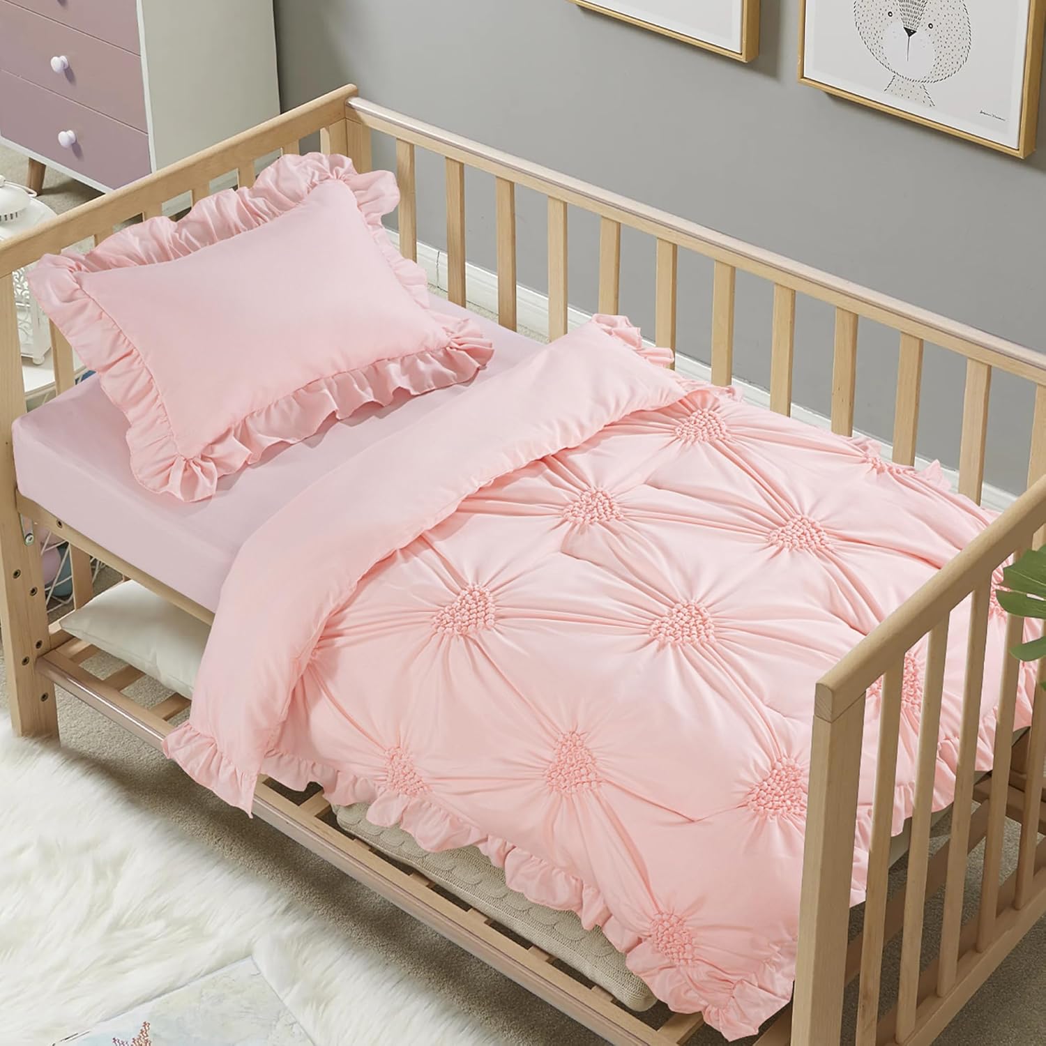HOMBYS princess pink crib bedding set front view showcasing the blush colored pinch pleat comforter inside a white wooden nursery crib
