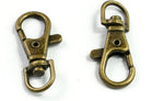 Antique bronze metal snap hook showing spring loaded gate mechanism.
