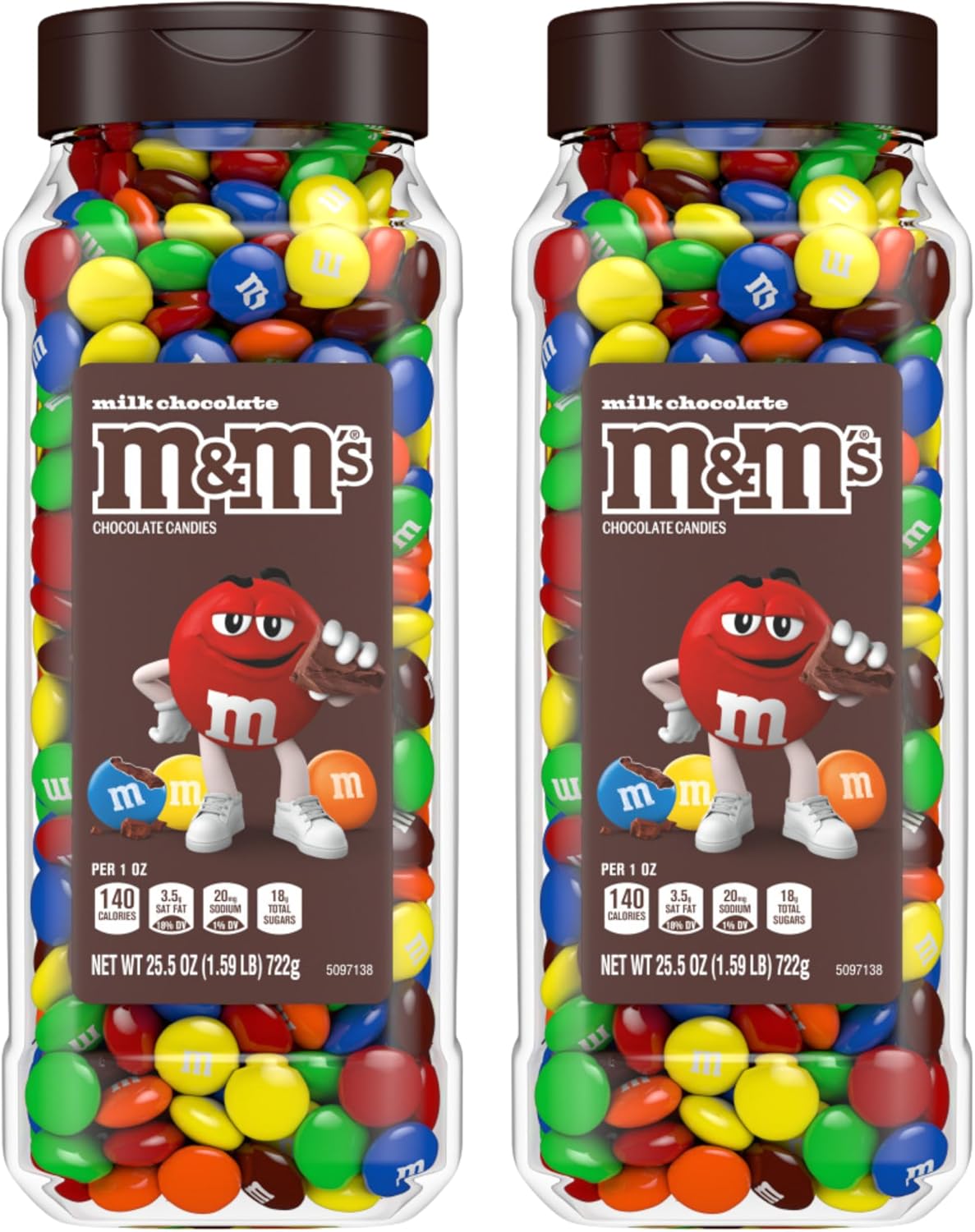 Hand holding a handful of colorful peanut chocolate candies next to the bulk jar