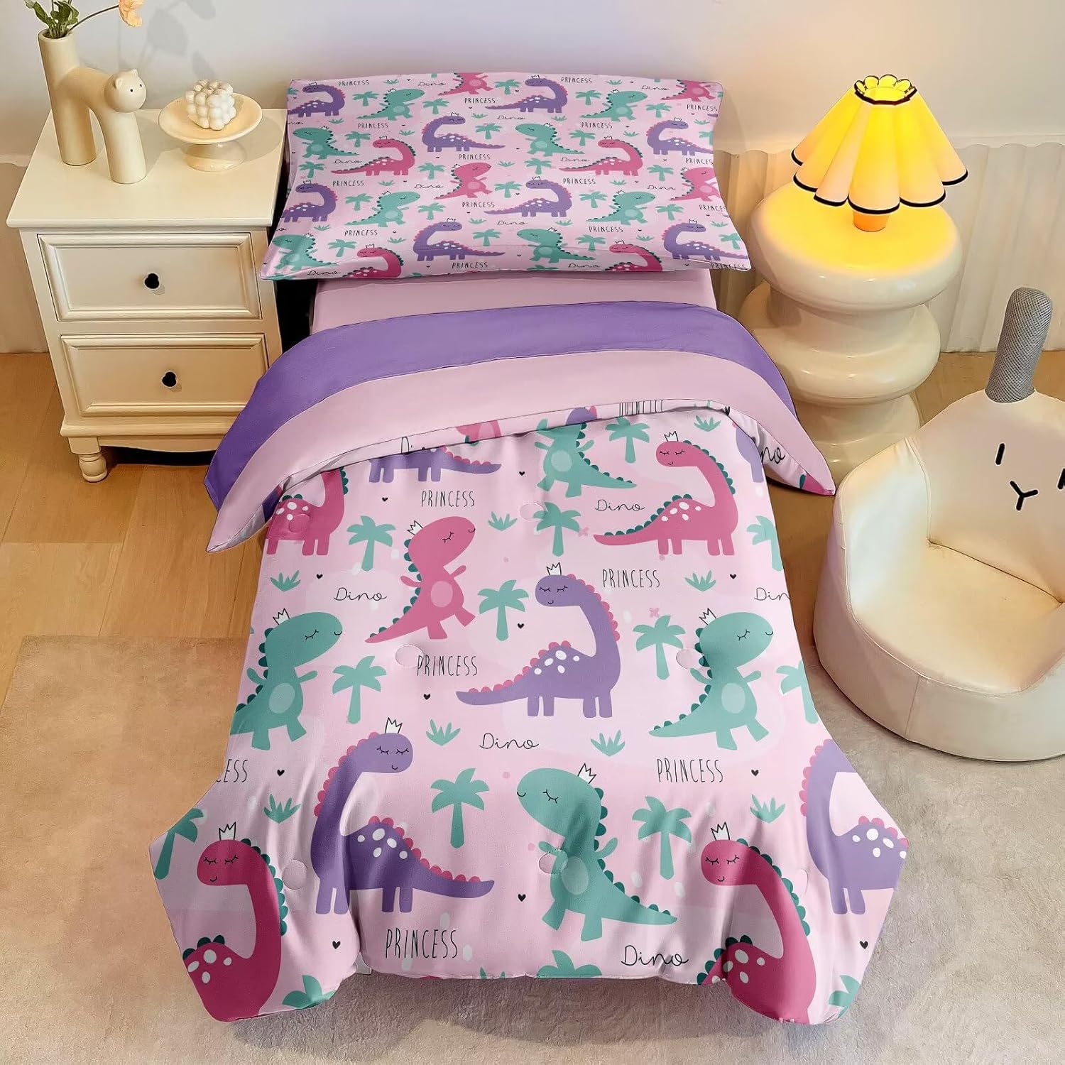 GRAT TIOC pink dinosaur toddler bedding set front view showcasing the comforter and matching pillow cover setup in a girl's bedroom.