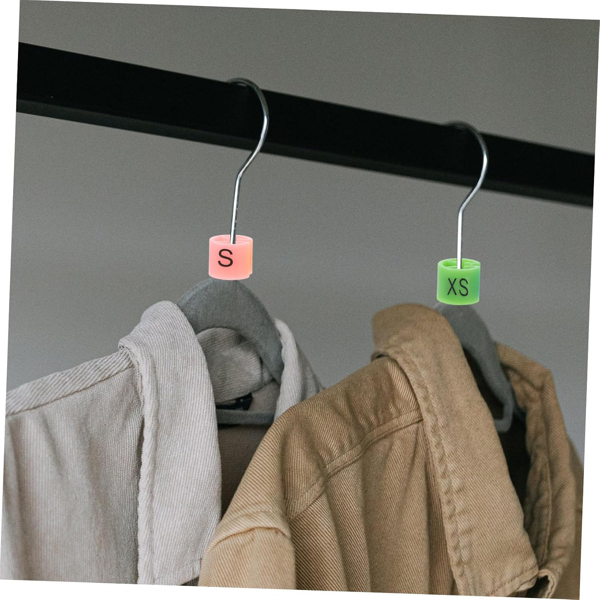 Clothing rack organized with color coded size markers