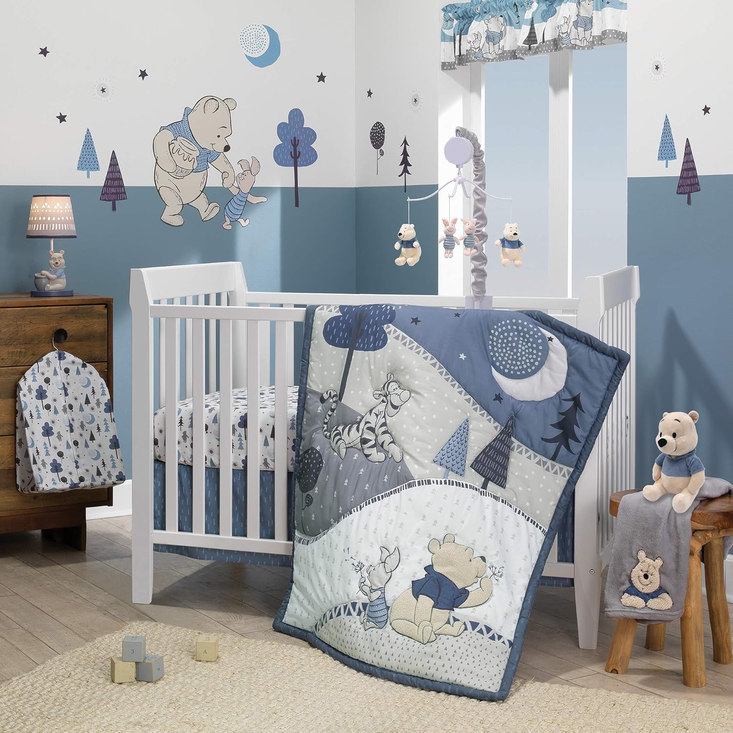 Lambs & Ivy Forever Pooh Three Piece Baby Crib Bedding Set front view featuring the blue and gray Winnie the Pooh comforter in a nursery