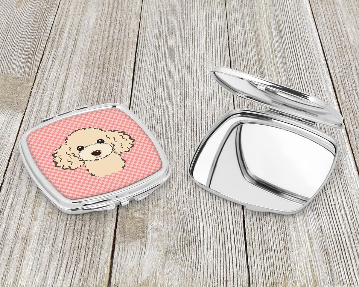Silvertone metal portable makeup mirror close up view of the artistic cartoon poodle design