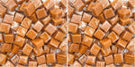 Premium green apple filled vanilla caramels being unwrapped for snacking