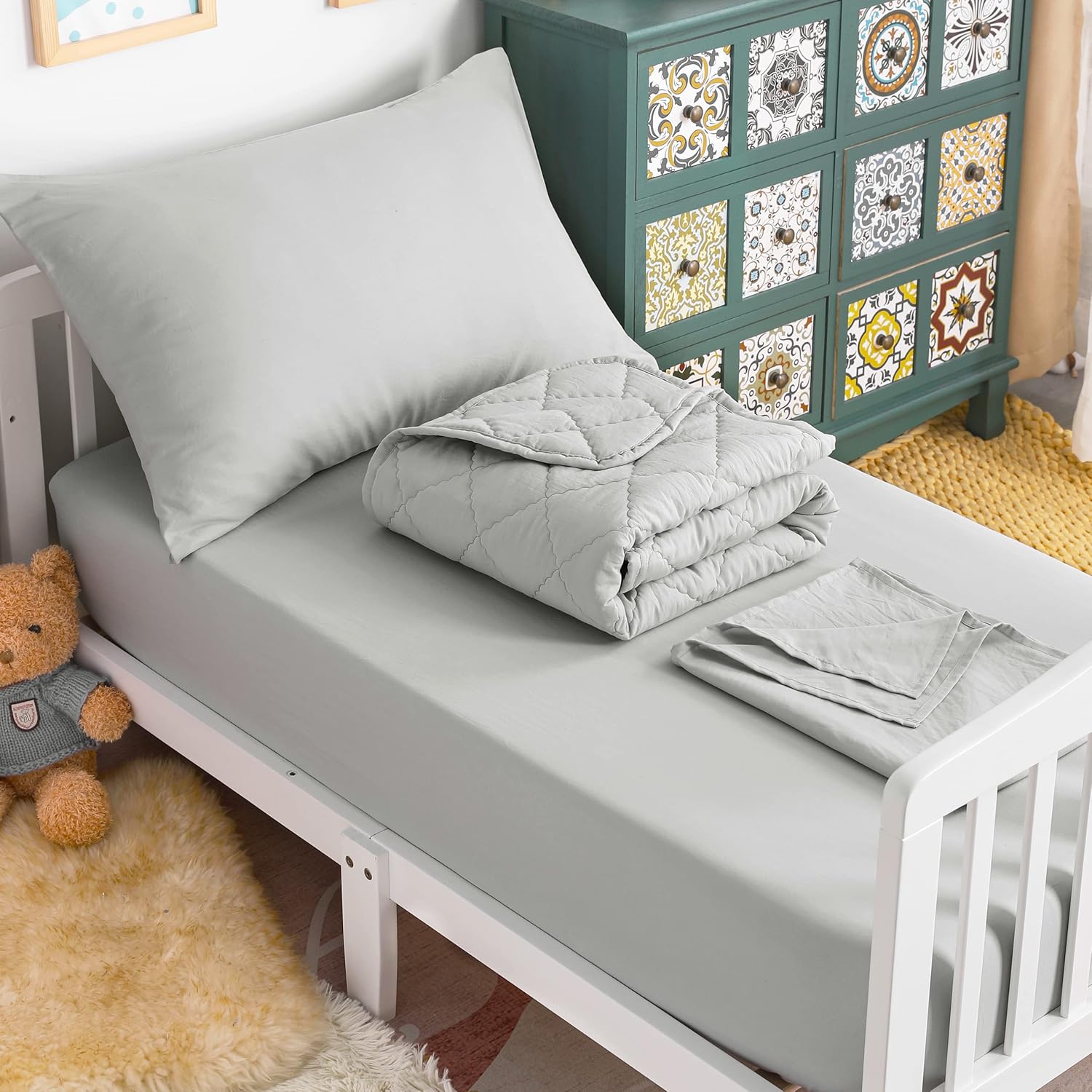 NTBAY toddler bedding set front view showcasing light grey quilted comforter and matching sheets in a neat nursery setup.