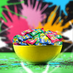 Green apple and watermelon flavor SourZap pieces unwrapped displaying rock candy consistency