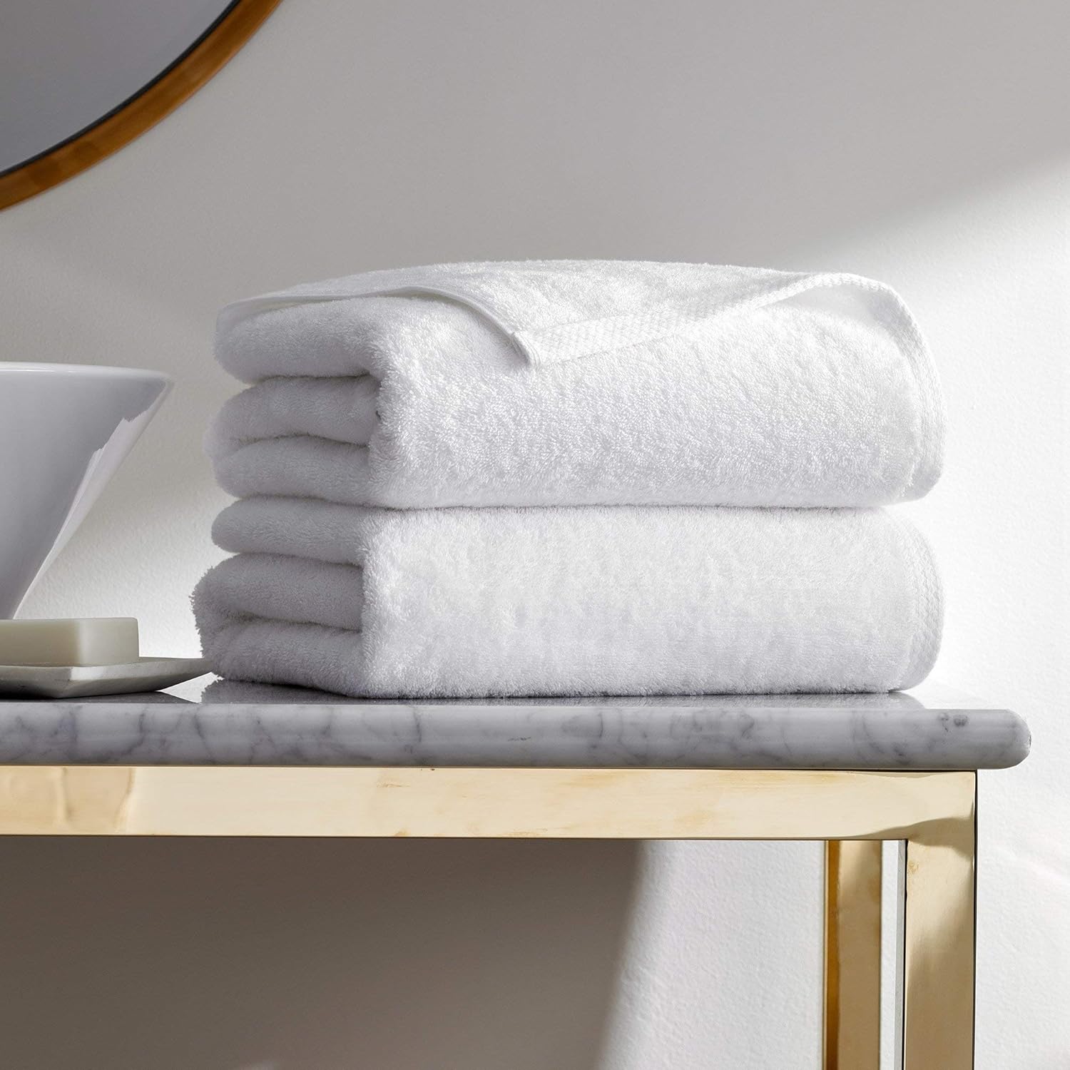H by Frette Simple Border Bath Sheet Set folded on a shelf.