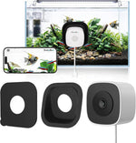 SnapBud 3MP 2K AI Reptile and Aquarium Camera front view showcasing the compact black housing and close-focus lens mounted on a glass surface.