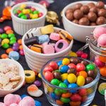 Assorted licorice candy mix pieces displayed on a holiday dessert table