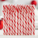 Individually wrapped red and white striped hard candies displayed on a clean background.