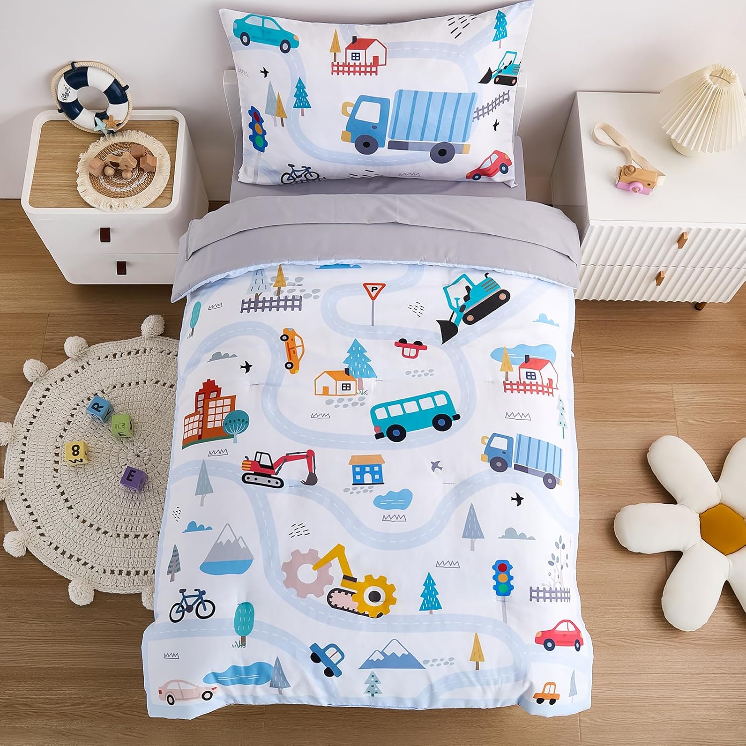 NacoMoco cars toddler bedding set front view with light blue vehicle printed comforter and sheets.