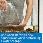API aquarium salt package next to freshwater fish tank setup