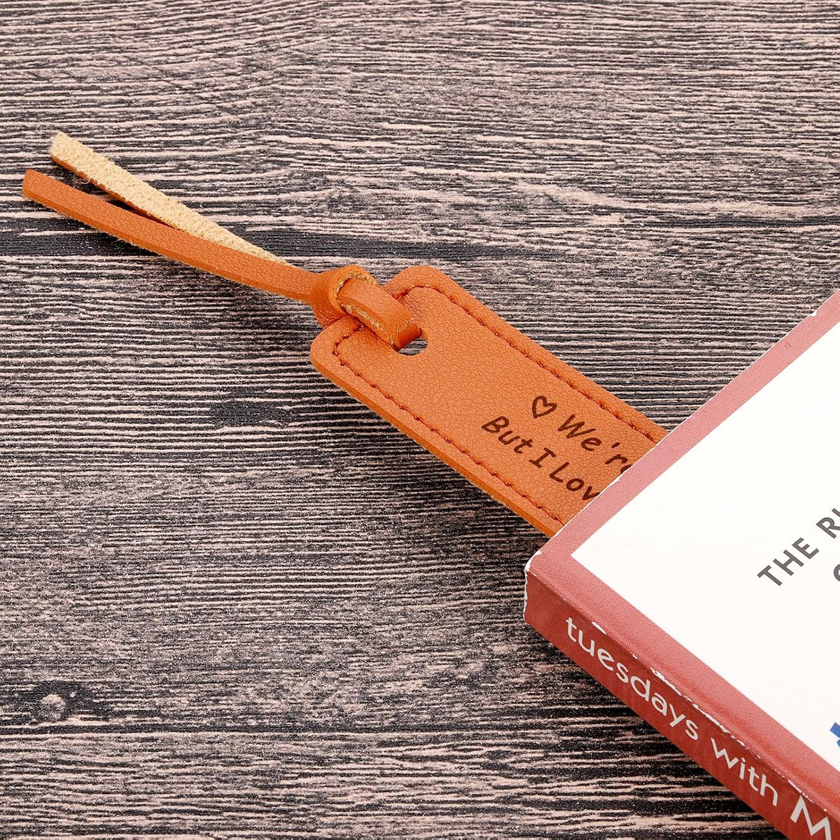 Close up view of stitched edges on brown leather bookmark