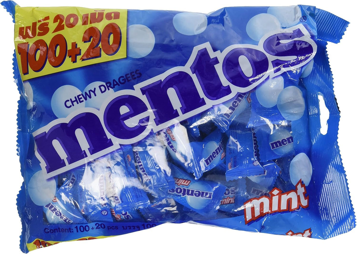 Bulk packaging of authentic Mentos imported fresh mint chewy dragees scattered to display individual pillow packs.