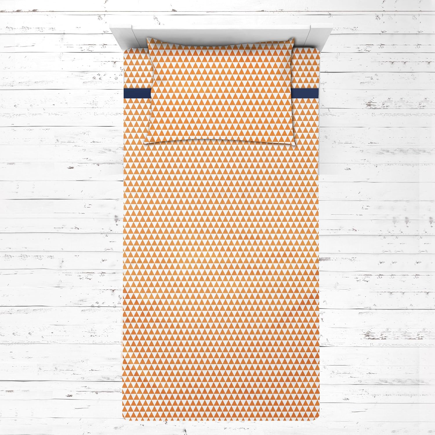 Bacati Aztec Triangles Cotton Muslin Toddler Bed Sheet Set front view highlighting orange and navy geometric print.