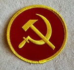 Round red USSR party patch on fabric surface