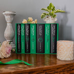 Harry Potter Slytherin hardcover books stacked showing green spines