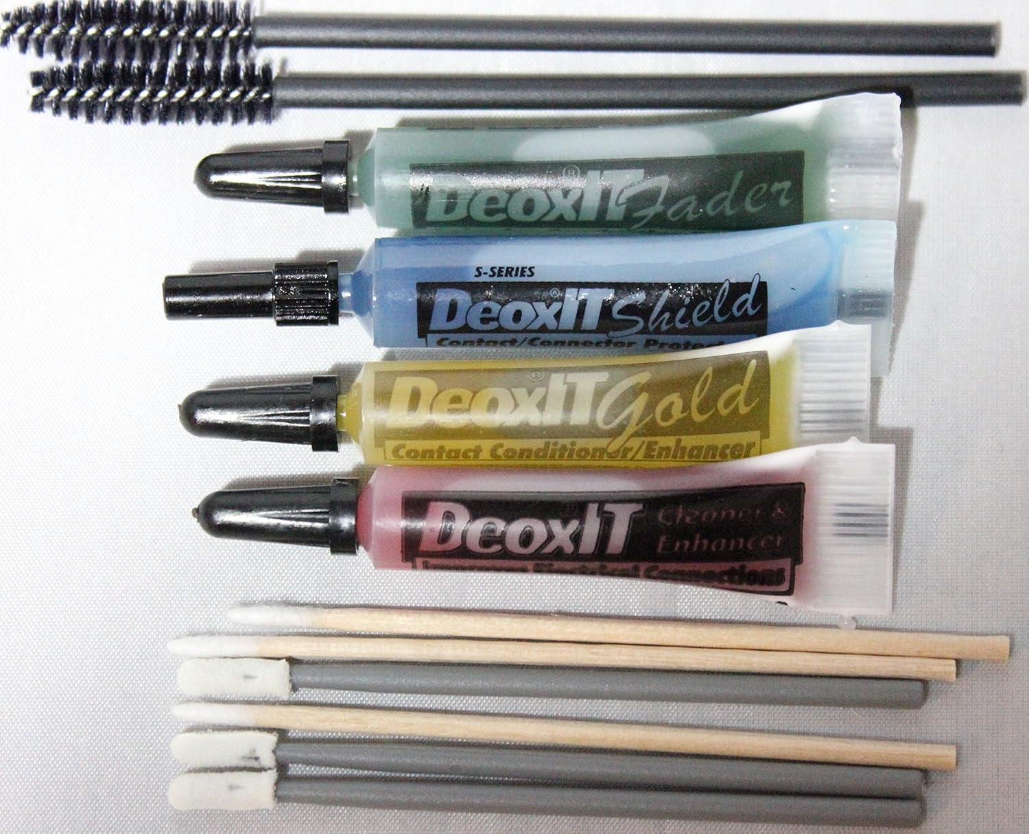 Deoxit Caig Squeeze Tube Essentials Kit front view showcasing four separate treatment liquids and precision application accessories.