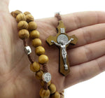 Detailed view of the wooden crucifix attached to the handmade prayer necklace