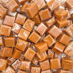 A handful of authentic USA imported individually wrapped green apple caramel candies