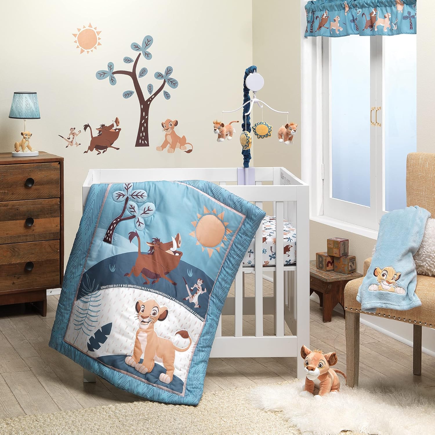 Lambs & Ivy Lion King Adventure mini crib bedding set front view featuring blue quilt and fitted sheets