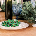 Individually wrapped ION Noisetta green foil chocolate pralines