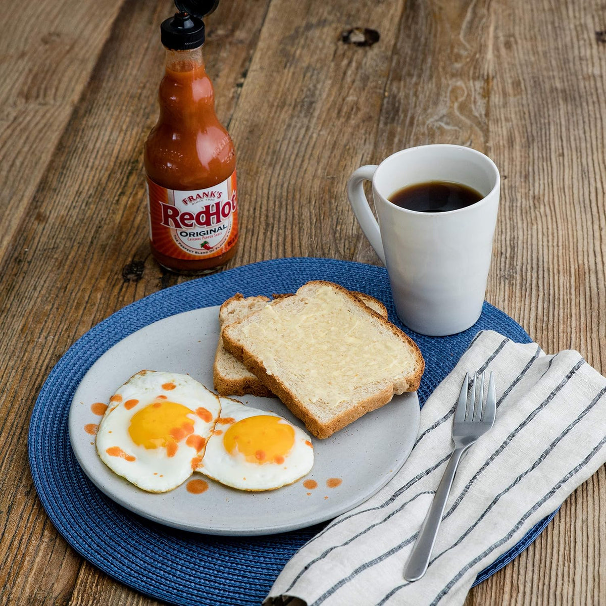 Frank's RedHot 12 fluid ounce bottle lifestyle shot