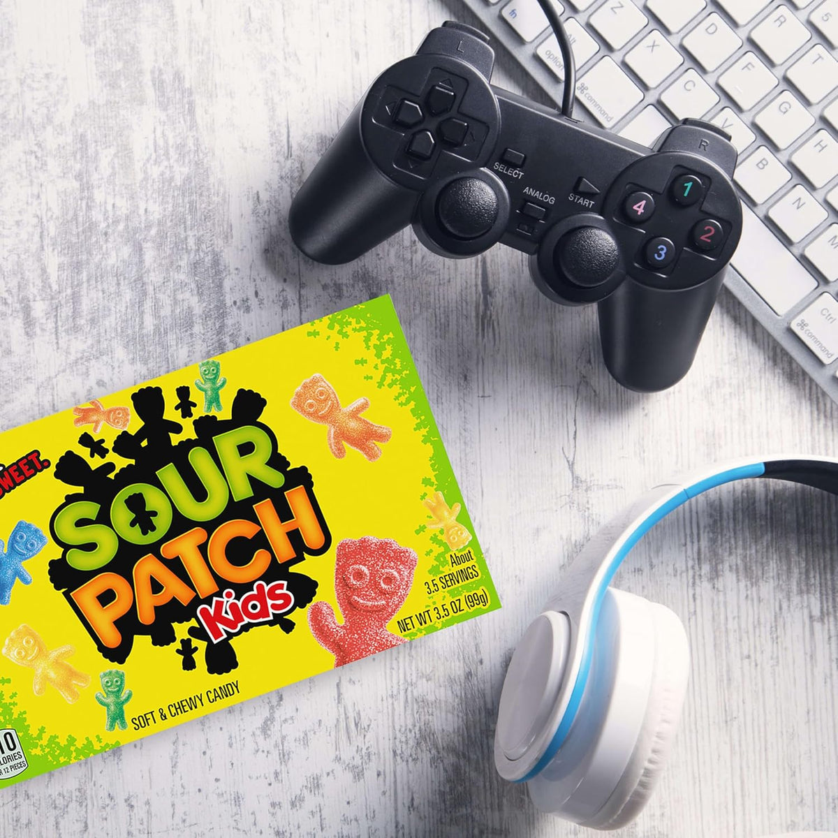 Sour Patch Kids soft and chewy treats held in hand to show the convenient bite size.