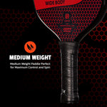Player holding the Onix pickleball paddle during indoor court play