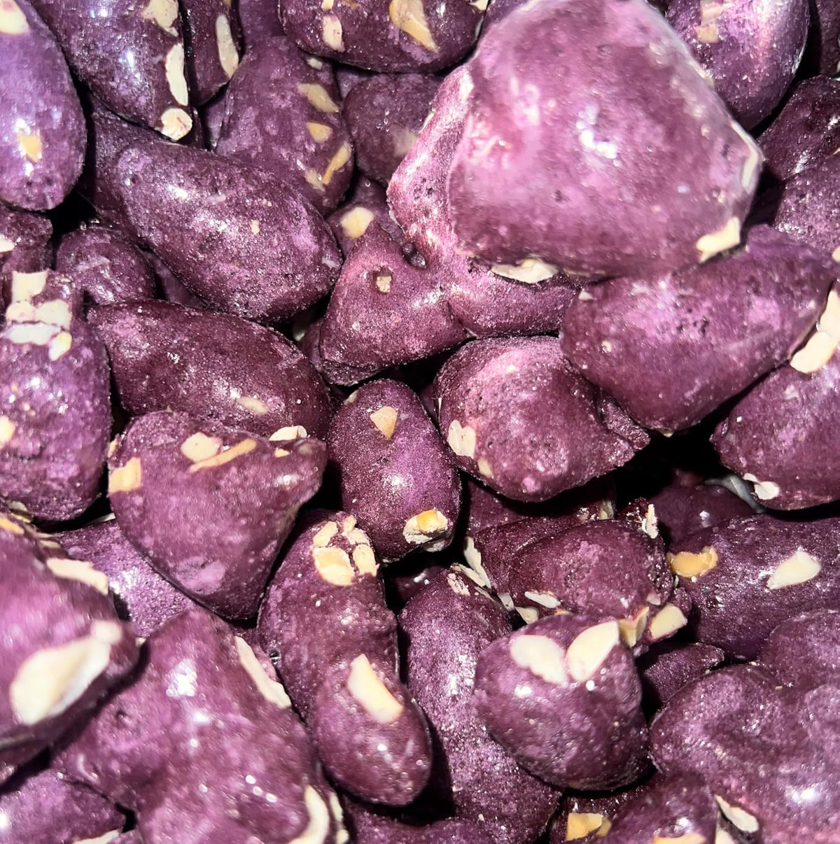 Close up of purple yam freeze dried candy chunks with macadamia nuts
