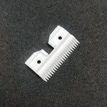 White ceramic pet clipper replacement blade parts on a clean backdrop