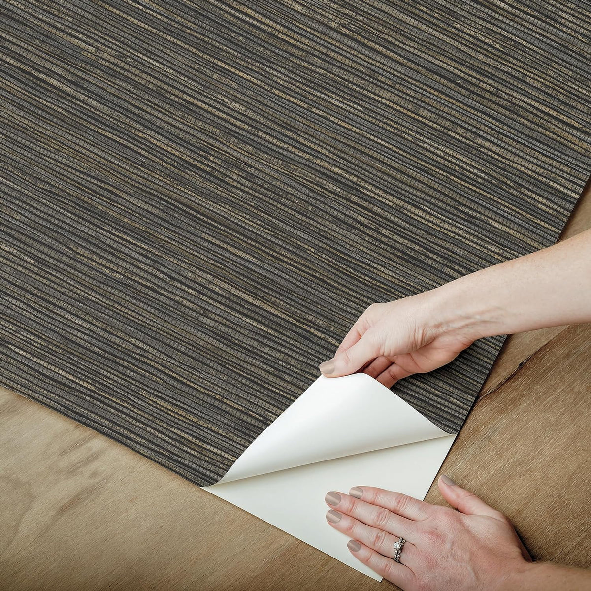 Textured woven design black grasscloth wallpaper sample angle shot