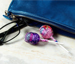 Assorted individually wrapped USA imported Jolly Rancher lollipops spread out on a table