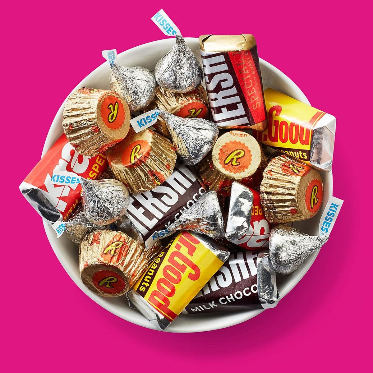 Assortment of miniature dark chocolate, milk chocolate, and peanut butter cups spread out