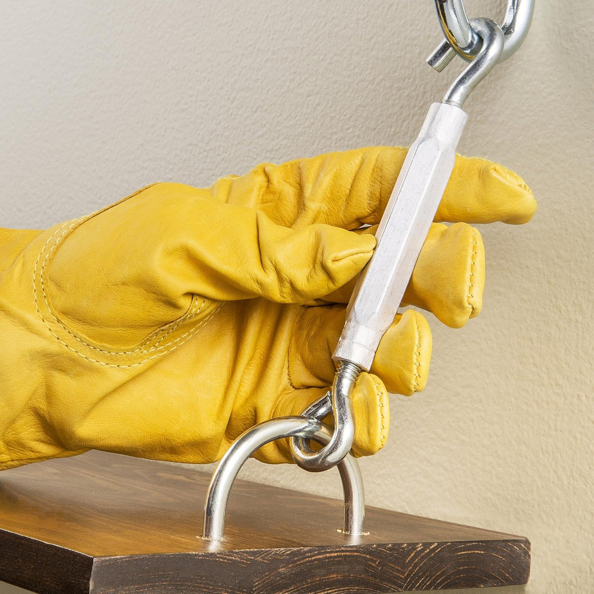 Hardware turnbuckle being used to tighten an outdoor steel cable