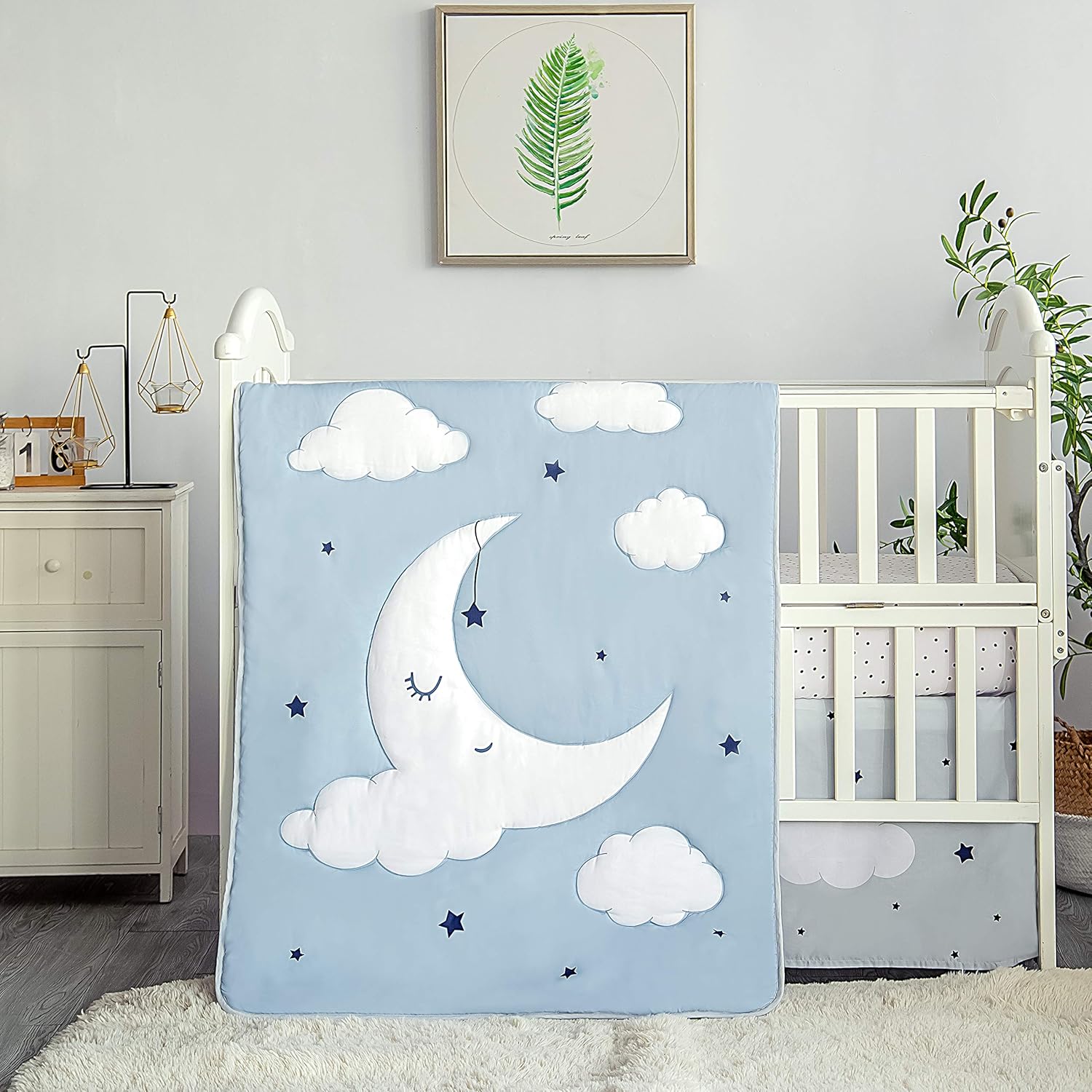La Premura Sleeping Moon baby crib bedding set front view showcasing the blue and grey quilted comforter on a nursery crib.