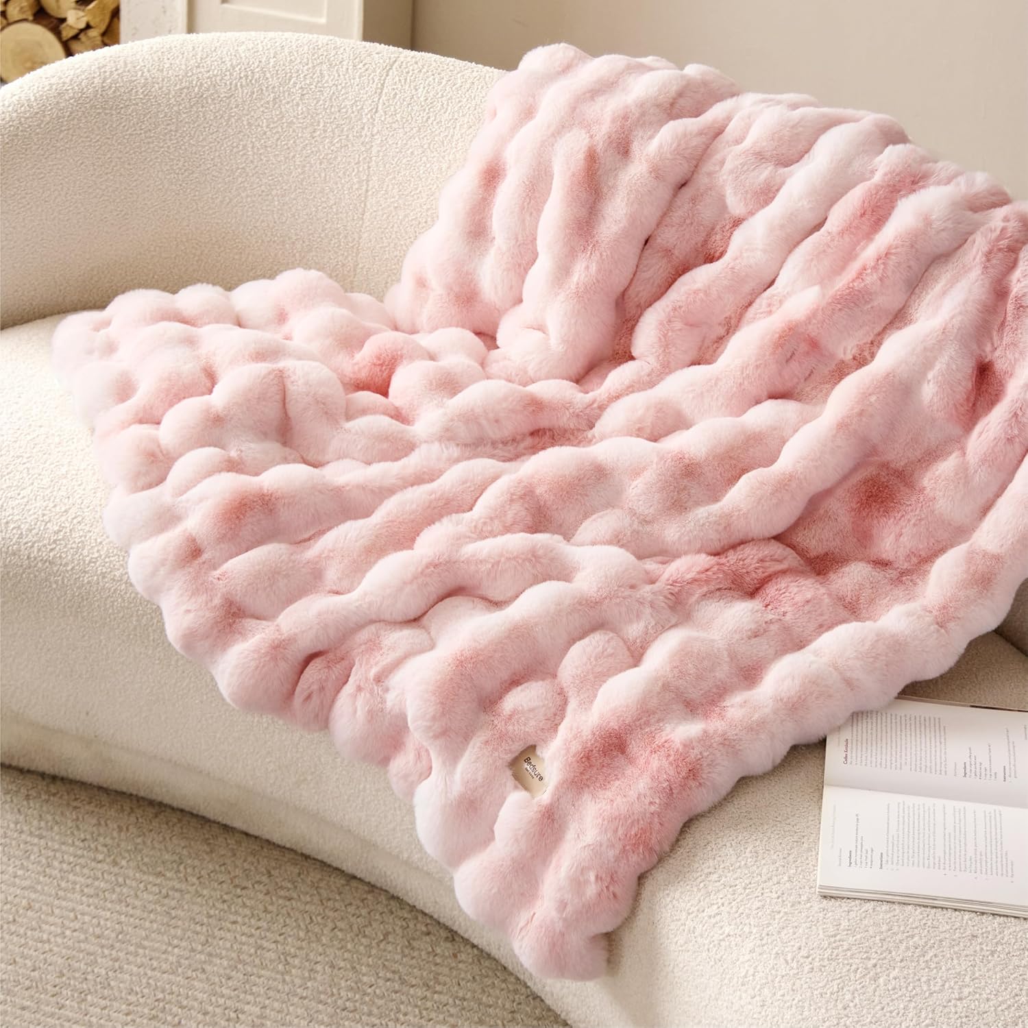Bedsure GentleSoft faux fur pink blanket front view draped on a cozy bedroom sofa