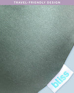 Bliss Neck Pillow Set being attached to a travel backpack handle using its snap button.