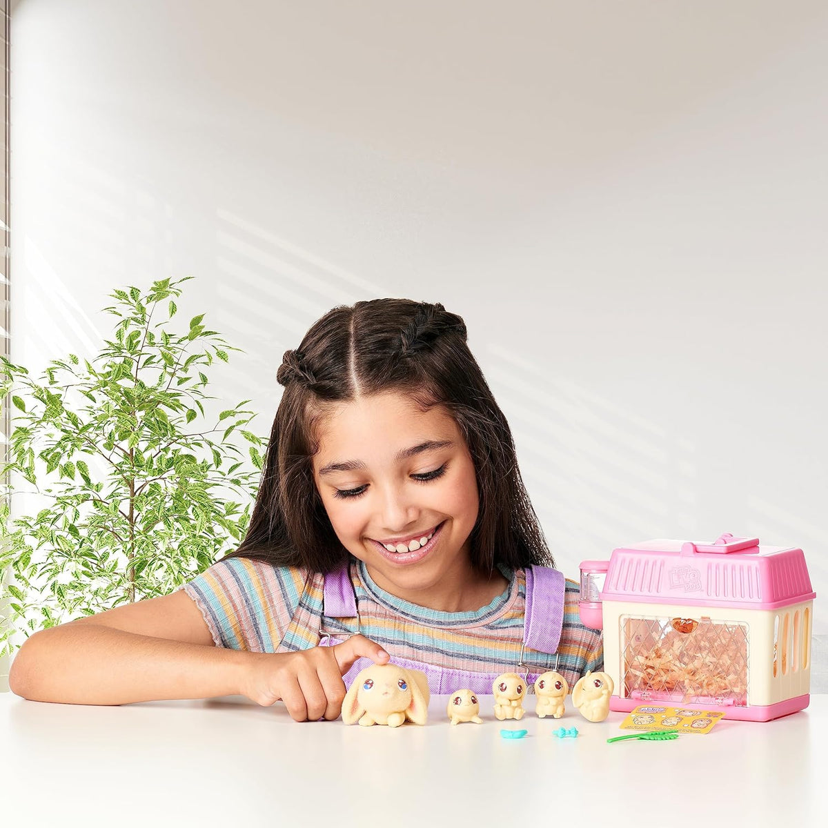 Child feeding the interactive mama bunny toy with celery