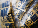 Single pouch of Edible Espresso dark chocolate snack being held for on the go energy visualization.