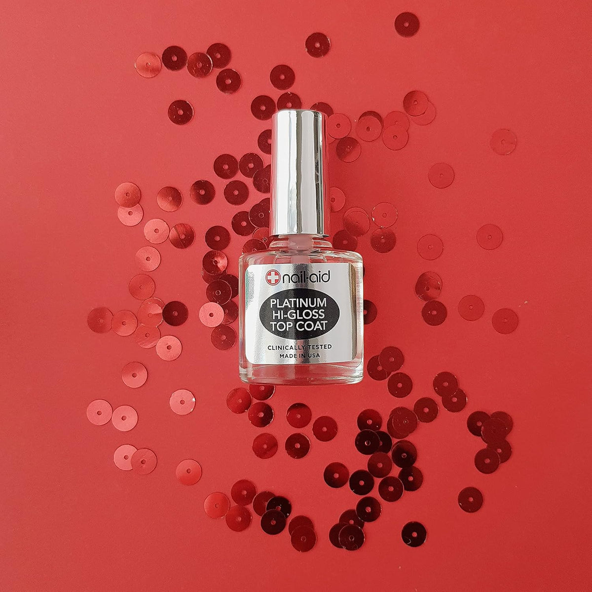 Nail-Aid 0.55 fluid ounce top coat bottle on a clean surface