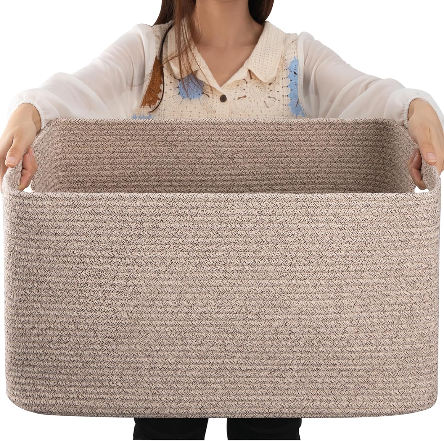 OIAHOMY 75L Large Woven Cotton Rope Storage Basket front view holding blankets in a modern living room