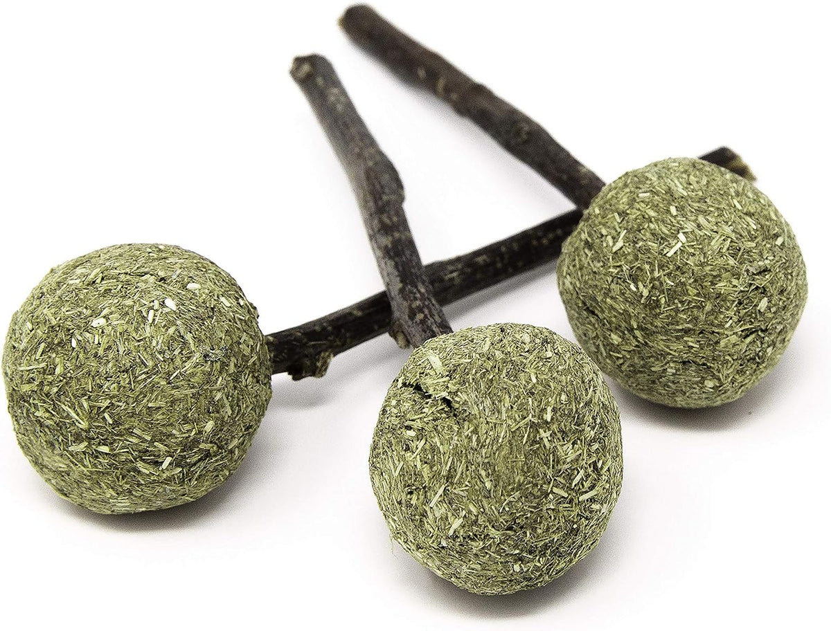 Close up of the compressed natural Timothy hay ball texture on top of the chewable stick.