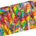 Whimsical multi-colored rainbow lollipops being placed into a party piñata filler.