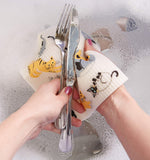 DII cellulose dishcloth absorbing liquid on kitchen counter