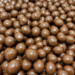 Nutic chocolate espresso coffee candy dragees poured out on a white surface