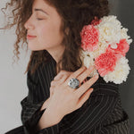 Aprilery statement ring angled shot highlighting multidimensional textured petals